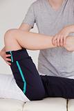 Portrait of a masseuse stretching the right leg of an athletic w
