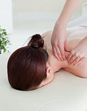 Portrait of a red-haired woman having a rolling massage