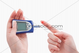Close up of a blood glucose meter utilization