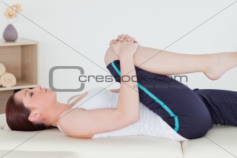 Sportswoman stretching her leg