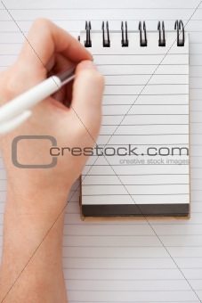 Woman hands writing on a notebook