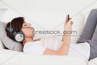 Good looking brunette woman writing a text on her mobile