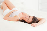 Gorgeous brunette woman posing while lying