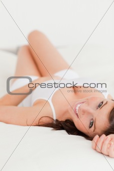 Attractive brunette female posing while lying