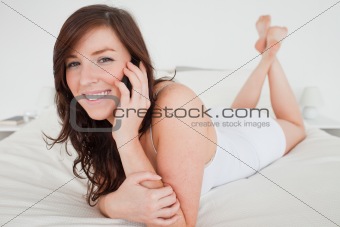 Beautiful female on the phone while lying