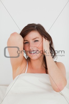 Pretty brunette woman awaking while sitting