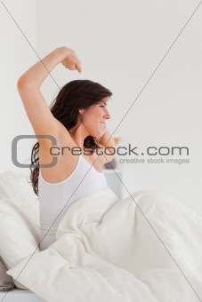 Charming brunette female posing while stretching