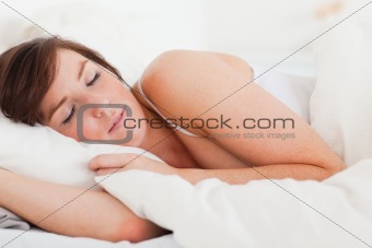 Beautiful brunette female having a rest while lying