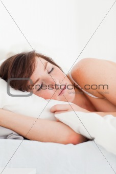 Good looking brunette female having a rest while lying