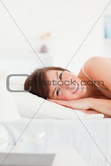 Cute brunette female posing while lying