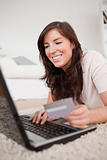 Young beautiful female making a payment with a credit card on th