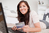 Young good looking female making a payment with a credit card on