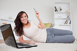 Attractive brunette female making a payment with a credit card o