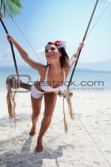 woman on a beach with swing