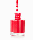Portrait of a red nail polish droping in its flask