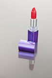 Portrait of a red lipstick with a purple tube
