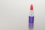 Red lipstick with a purple tube
