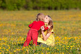 mother and son picking flowers at dandelion field in spring