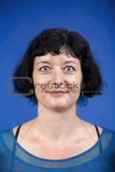 portrait of middle-aged woman with dark hair - isolated on blue
