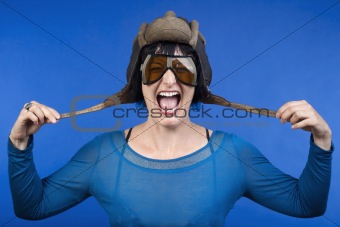 woman with old army tank personal helmet, laughing - isolated on blue