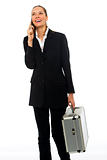 Young businesswoman on a cell phone with a briefcase on white background studio