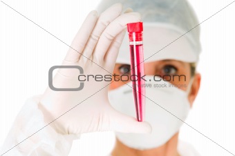 female doctor with mask holding a test tube