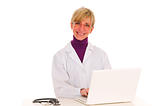 female doctor at the desk with stethoscope and laptop