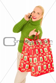 Woman with mobile and bags with Christmas gifts