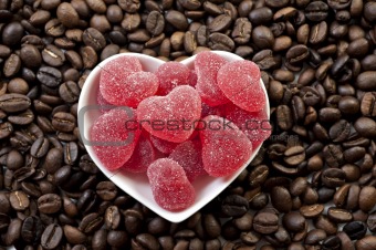 Red heart shaped jelly sweets and coffee beans