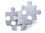 Stainless steel puzzle pieces on white background