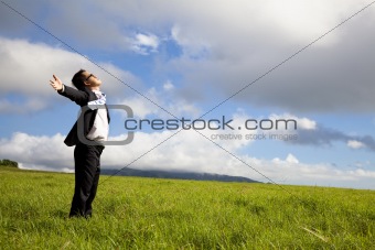 young man in green  field under blue skies