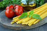 cherry tomatoes on a branch, basil, pasta and olive oil