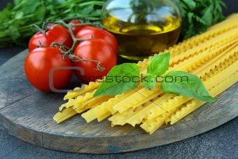 cherry tomatoes on a branch, basil, pasta and olive oil
