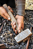 Detail of dirty hands holding hammer - blacksmith