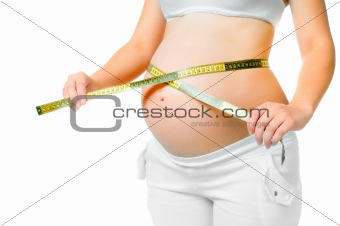 pregnant woman measuring belly