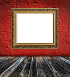 old  elegant golden frame on red plaster rough background 