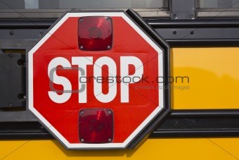 Stop sign on yellow school bus