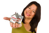 Attractive Multiethnic Woman Holding a Small House Out In Front of Her Isolated on a White Background.