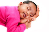 newborn baby girl peaceful asleep in farthers hands