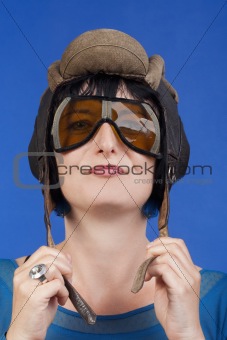 woman with an old army tank personal helmet- isolated on blue