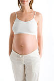Pregnant woman with exposed belly smiling