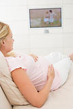 Pregnant woman watching television