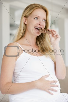 Pregnant woman with chocolate smiling