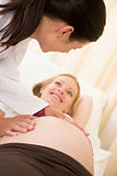 Pregnant woman getting check up from doctor