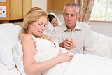 Pregnant woman in pain with husband in hospital