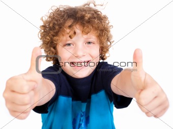 Smiling cute little boy gesturing thumbs up