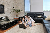 happy young family have fun and working on laptop at home