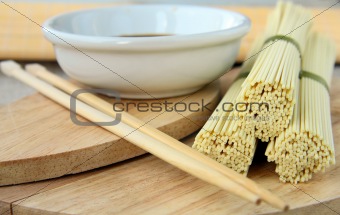 Japanese egg noodles and soy sauce on a wooden background