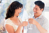 Couple toasting champagne and smiling