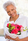 Woman holding flowers and smiling